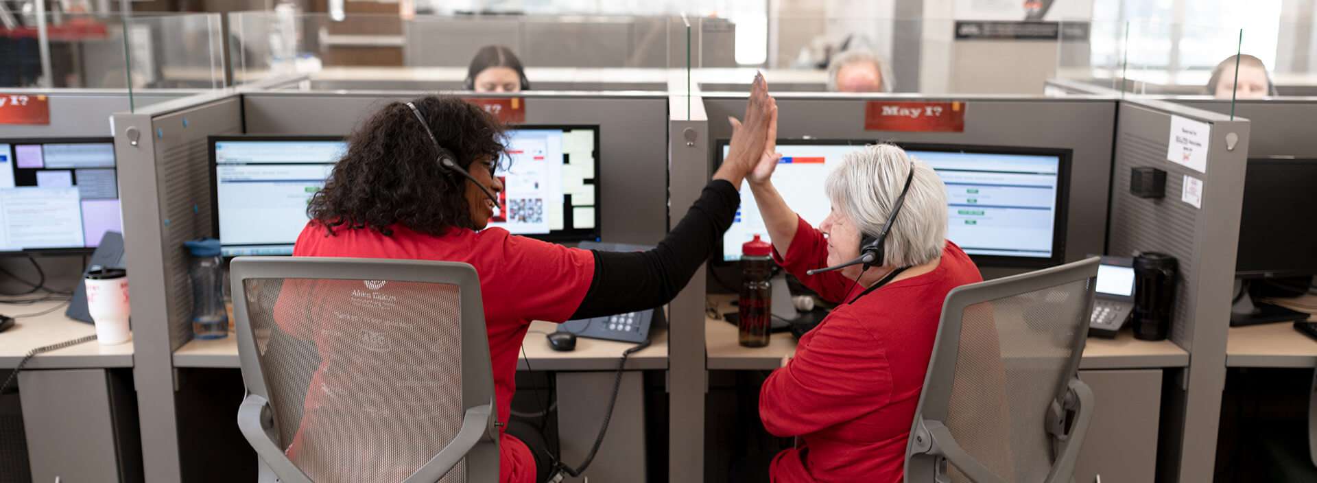 Two call centre colleagues high-fiving