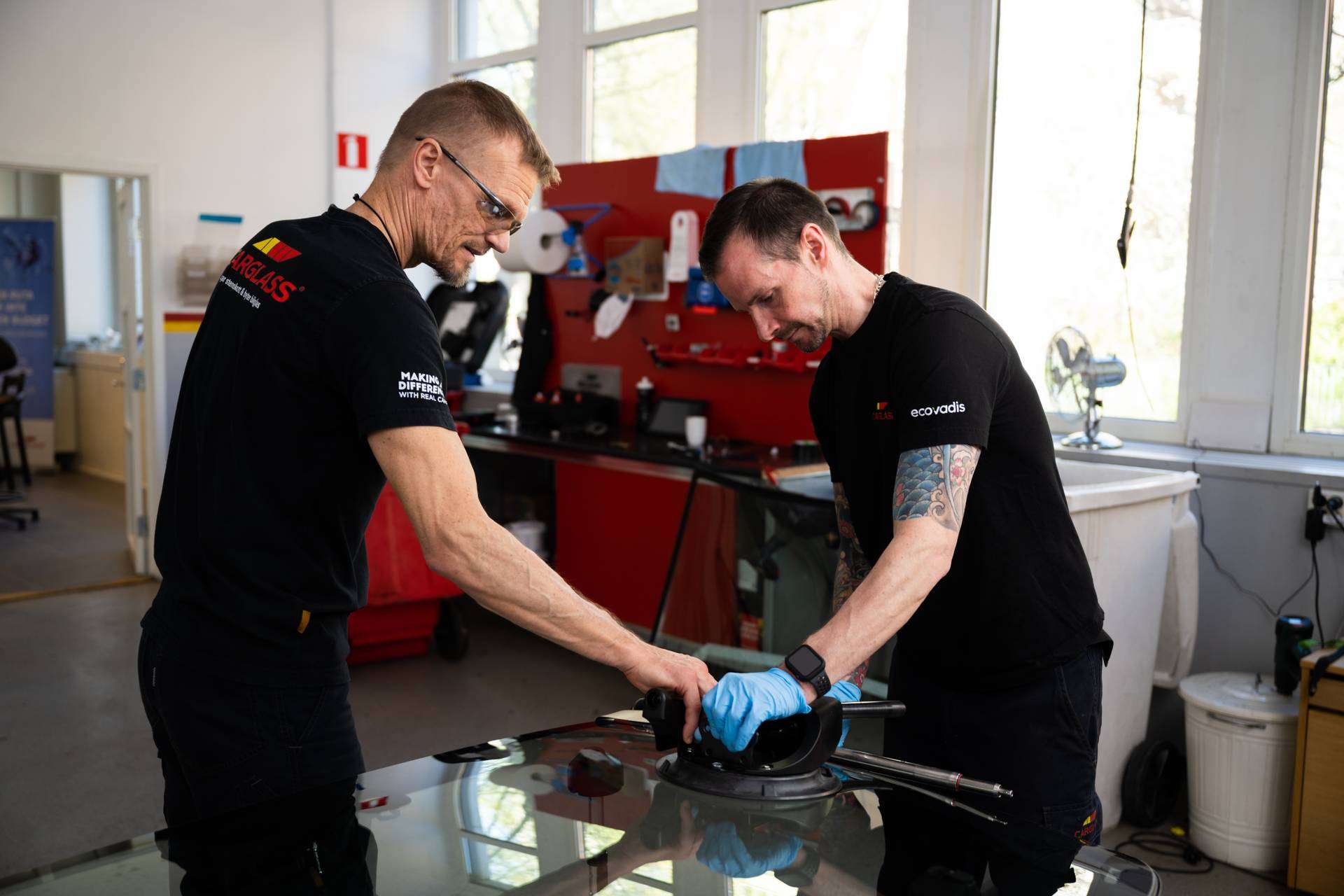 Two technicians working on windscreen