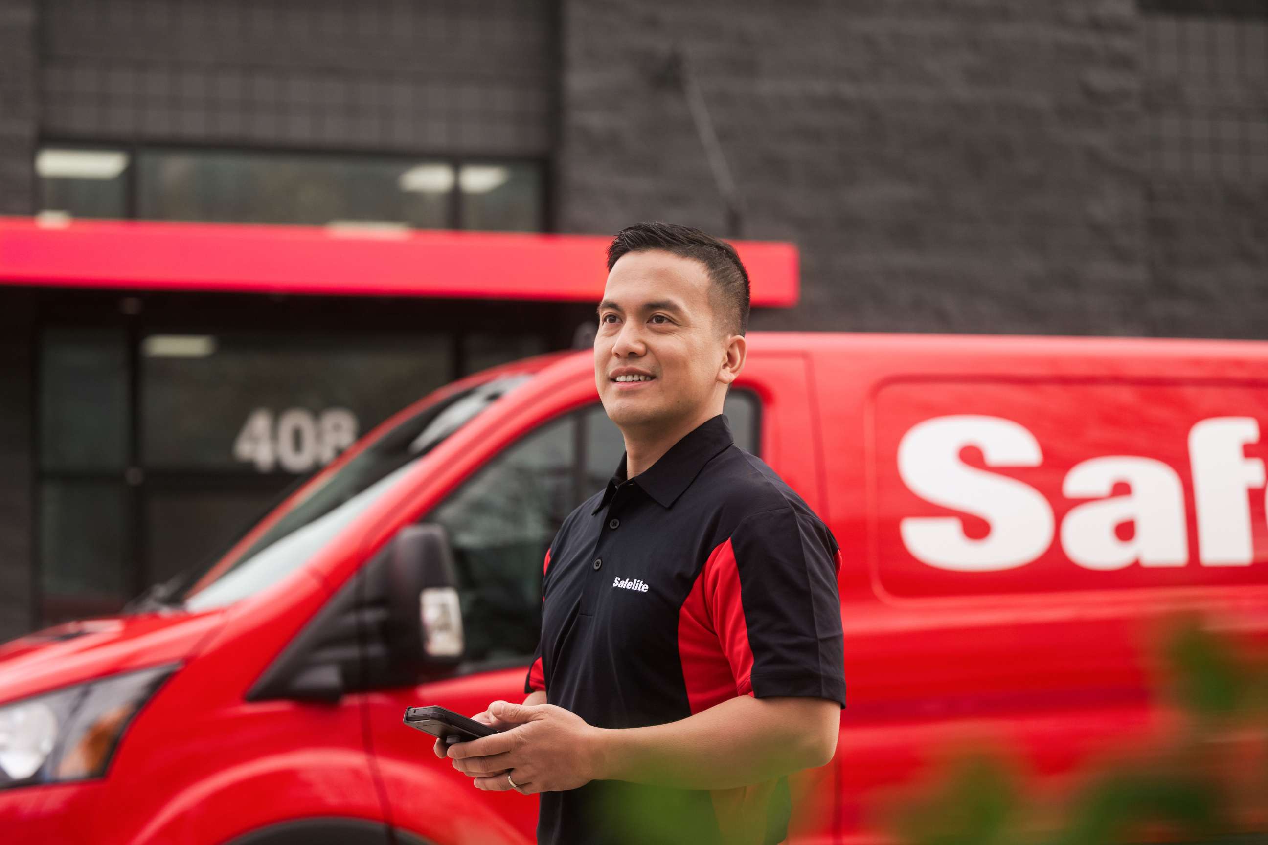 Safelite tech in front of van