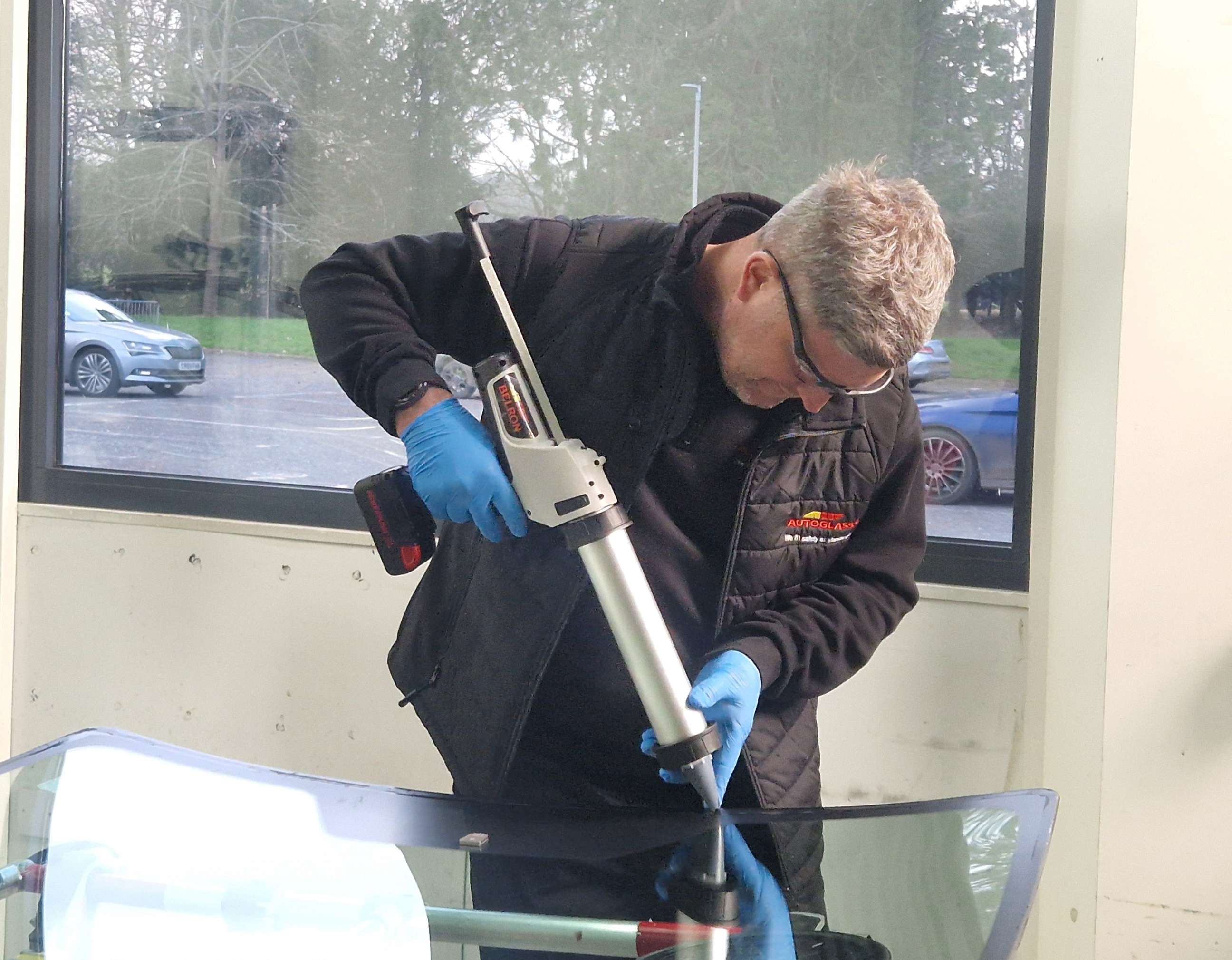 Technician with adhesive gun