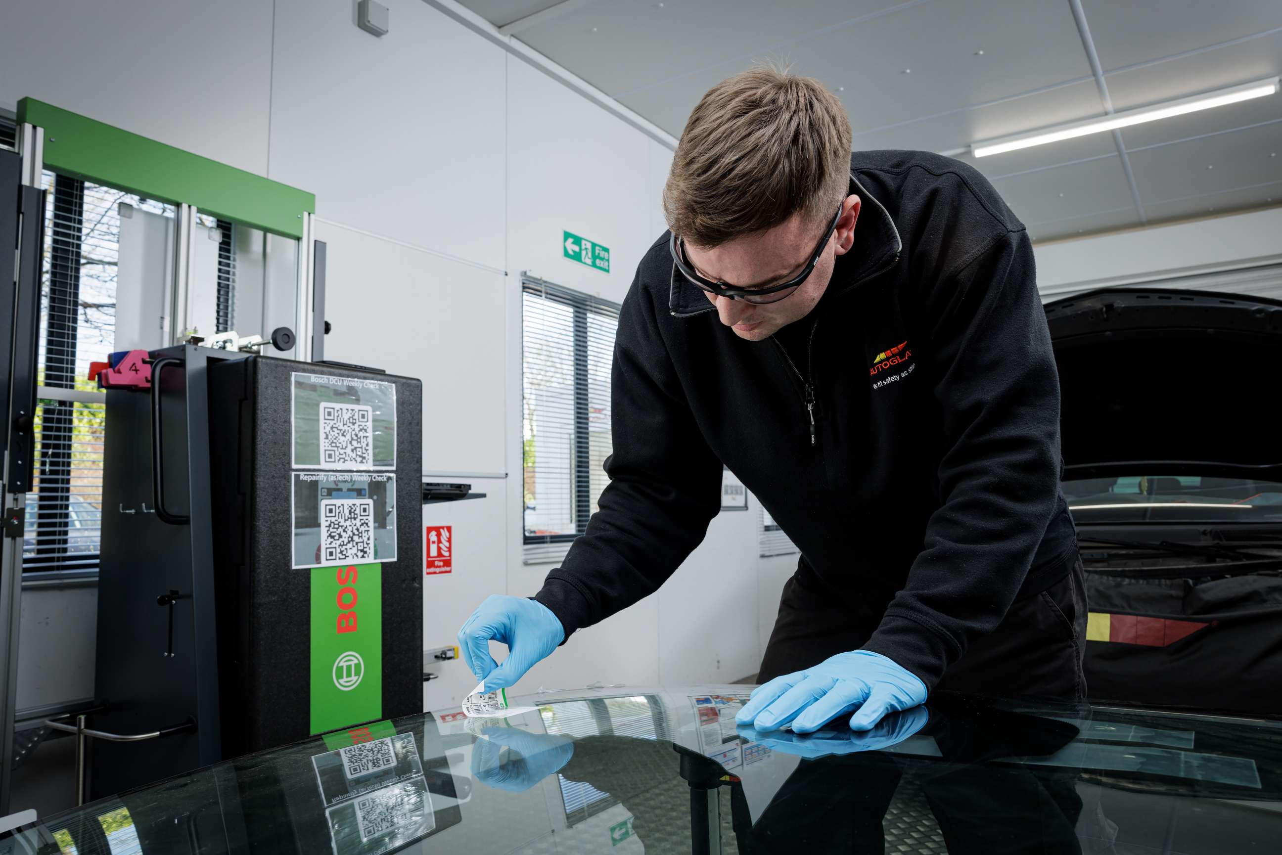 Technician working windscreen