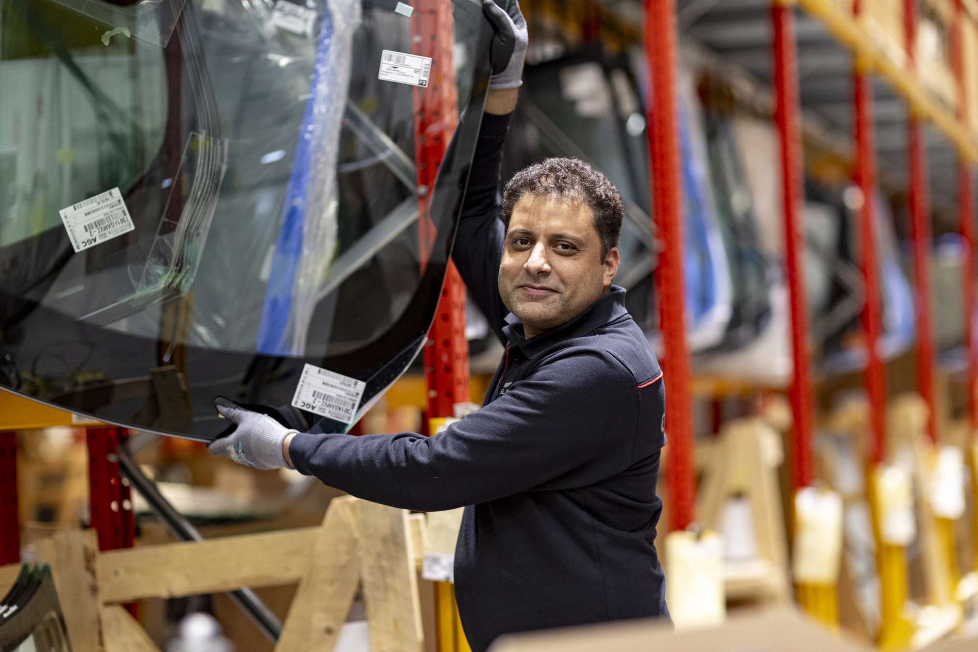 Warehouse operative removing Windscreen