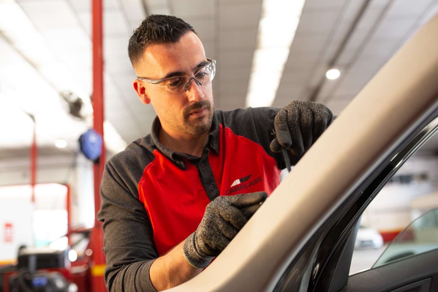 Technician fitting windscreen