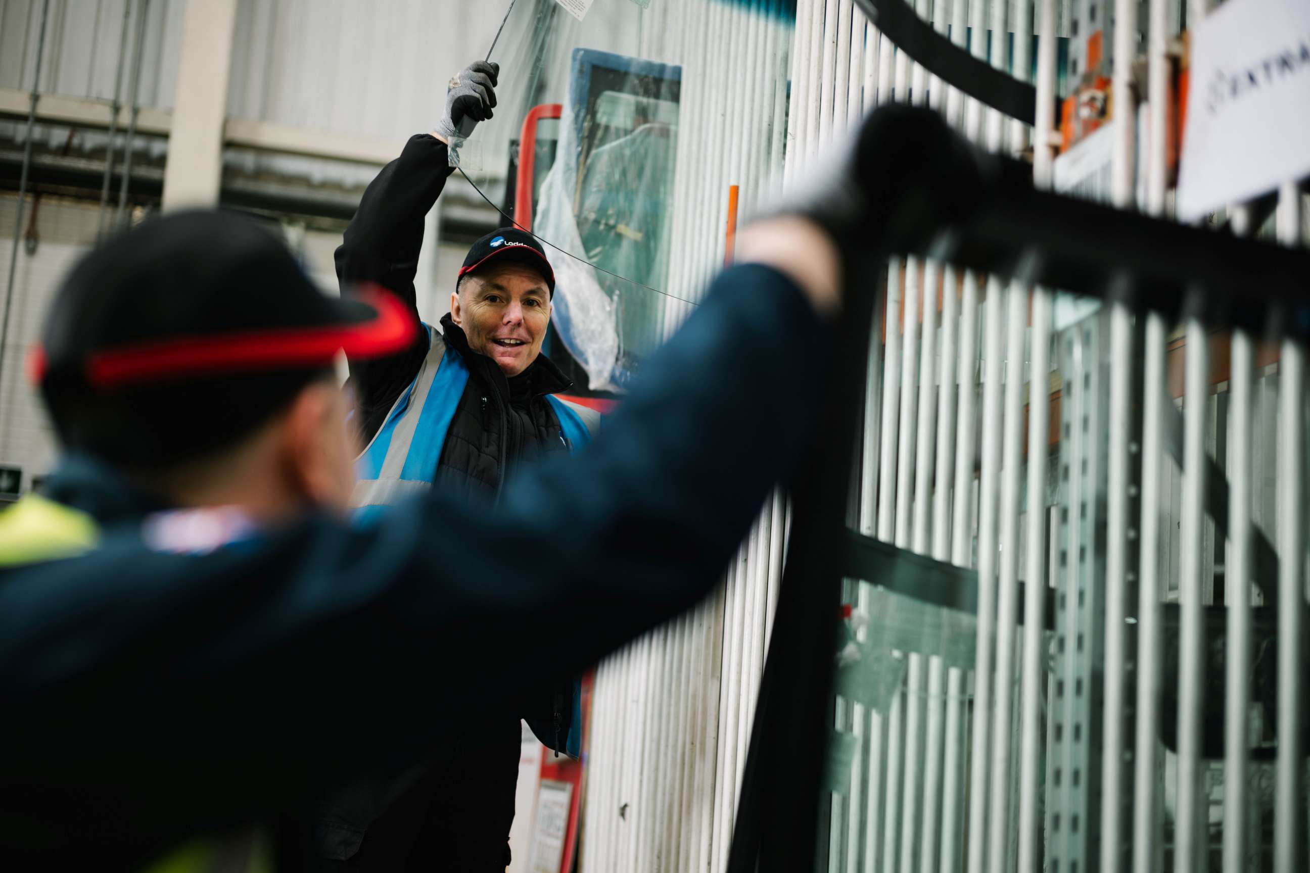 Warehouse operatives unloading windscreens