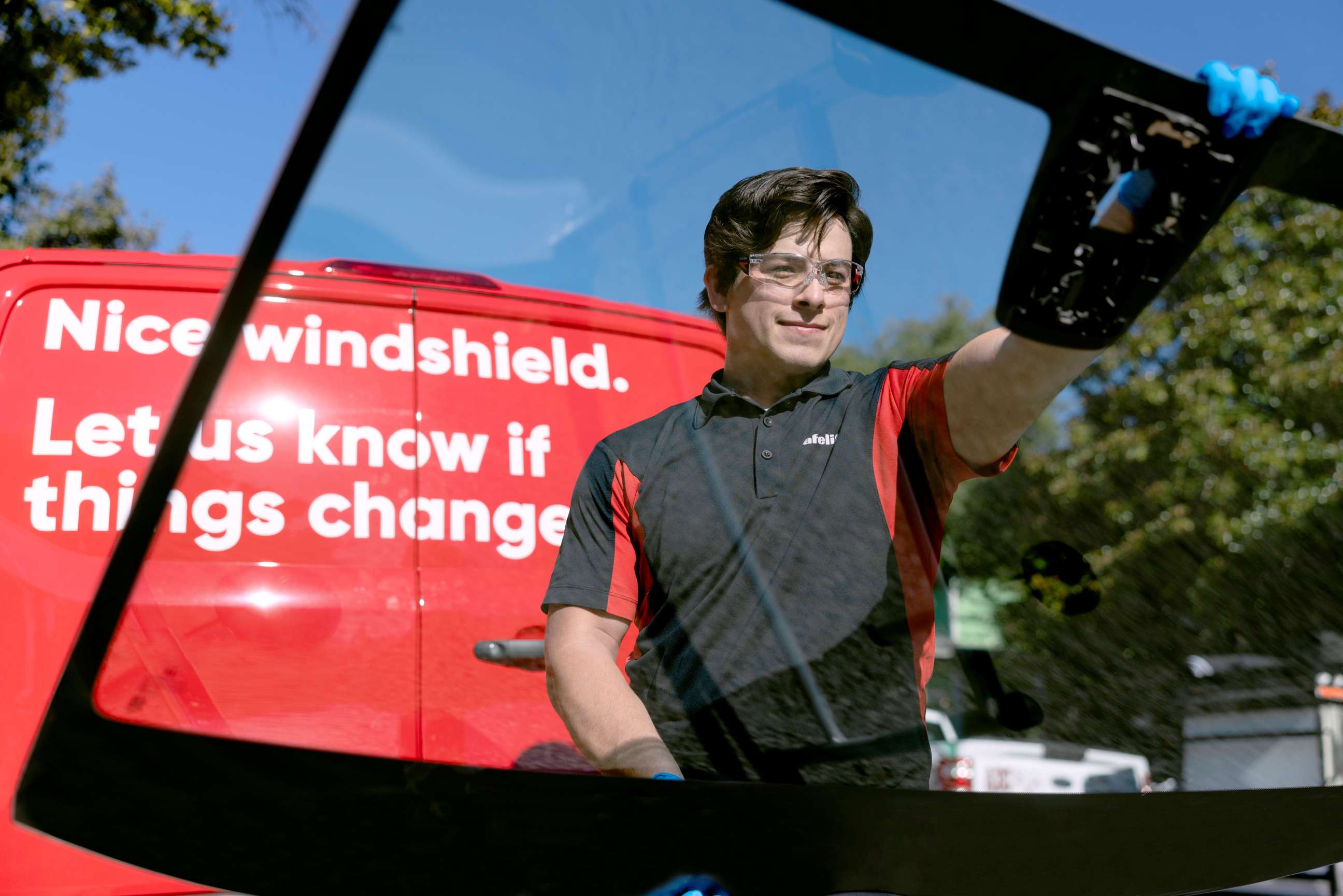 Safelite technician holding glass