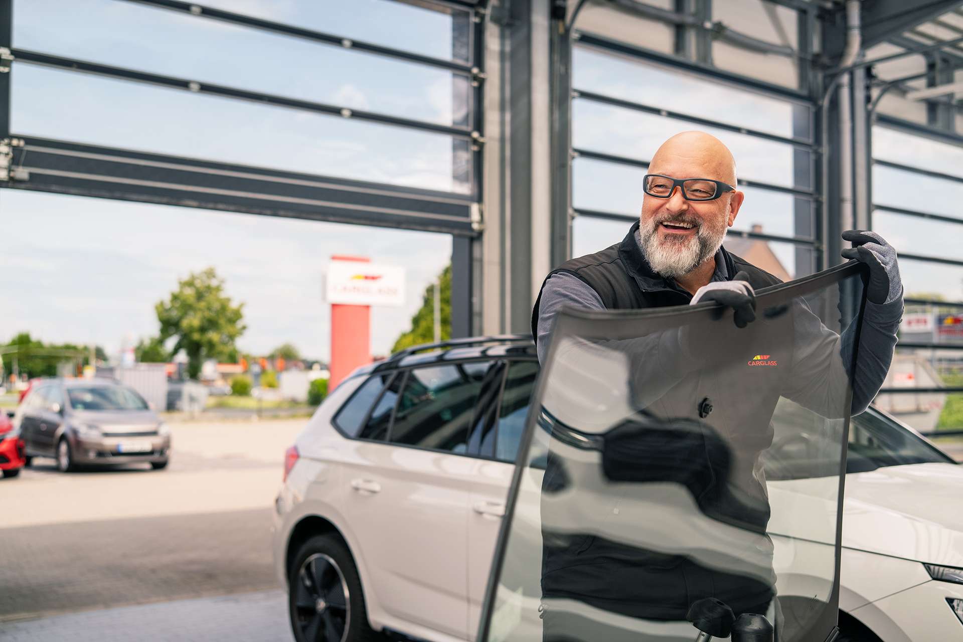 Technician holding windscreen