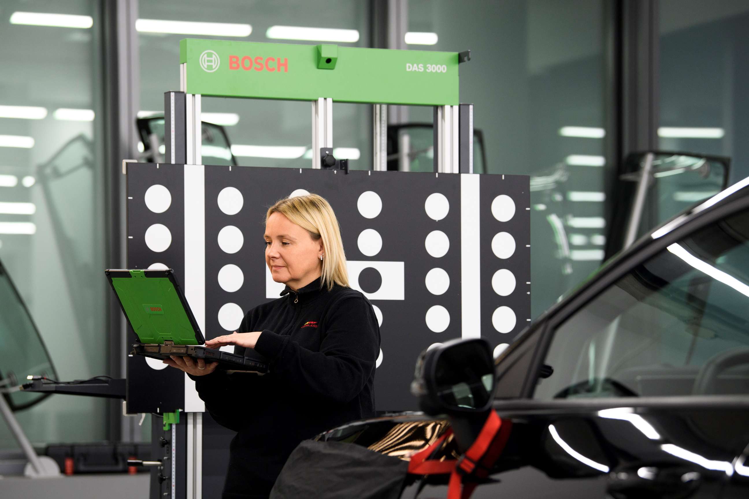 Technician recalibrating a windscreen