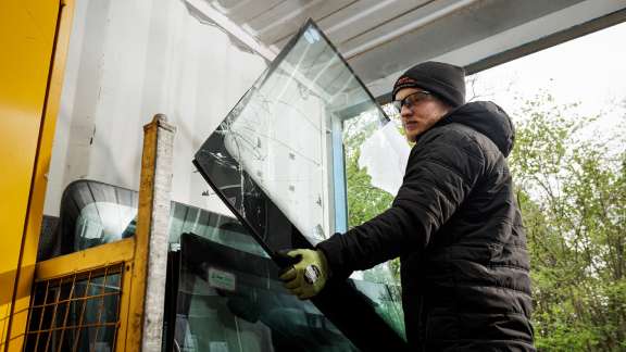 Technician recycling windscreen