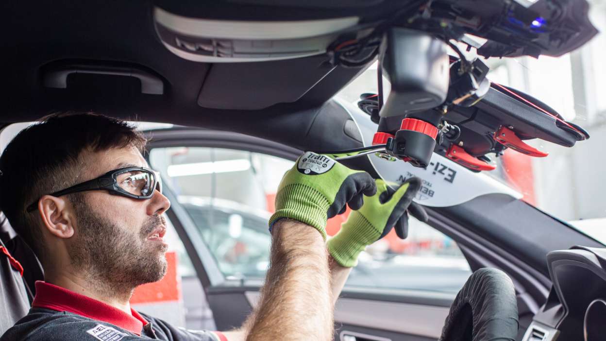 Technican removing a windscreen