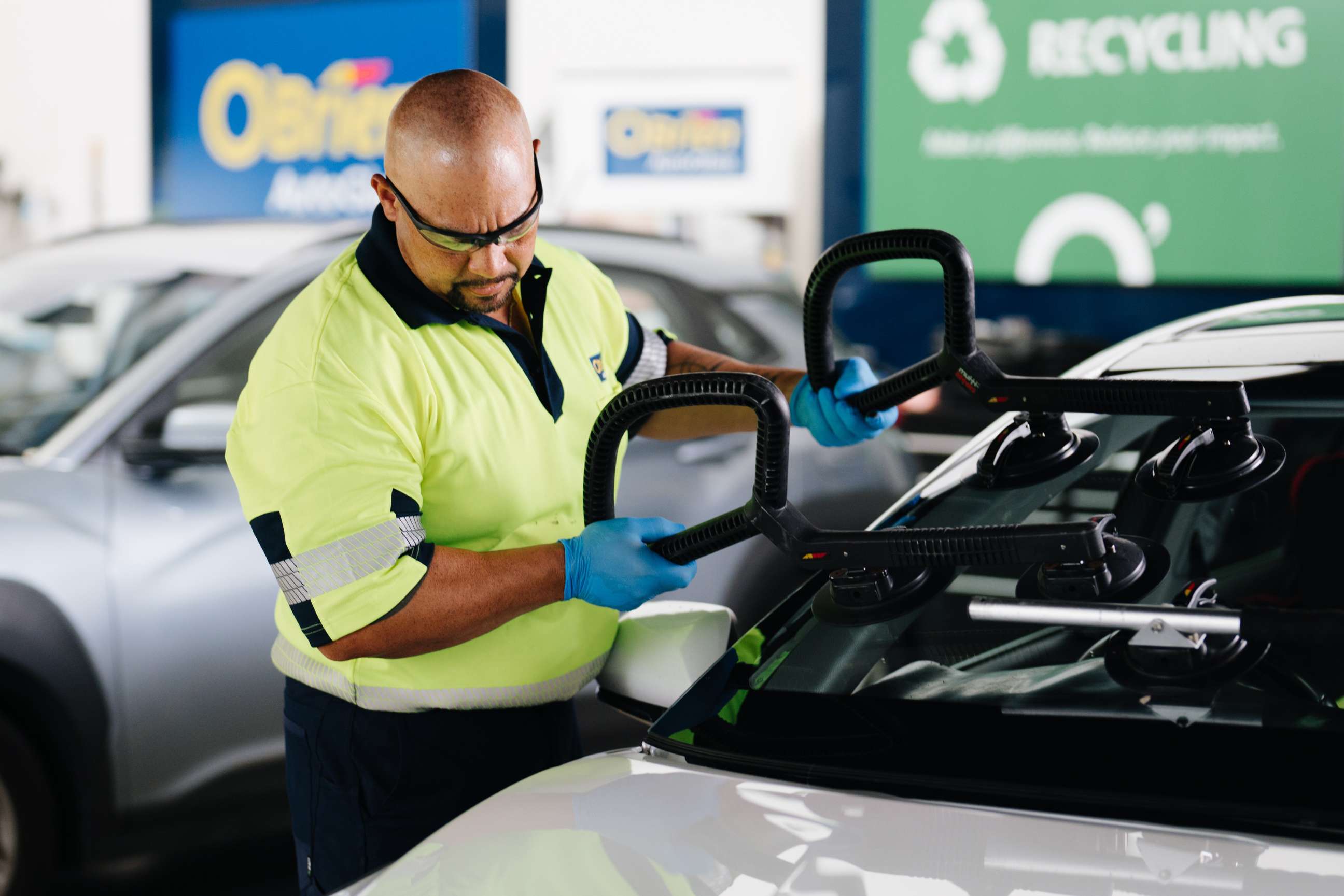 Technician replacing a windscreen