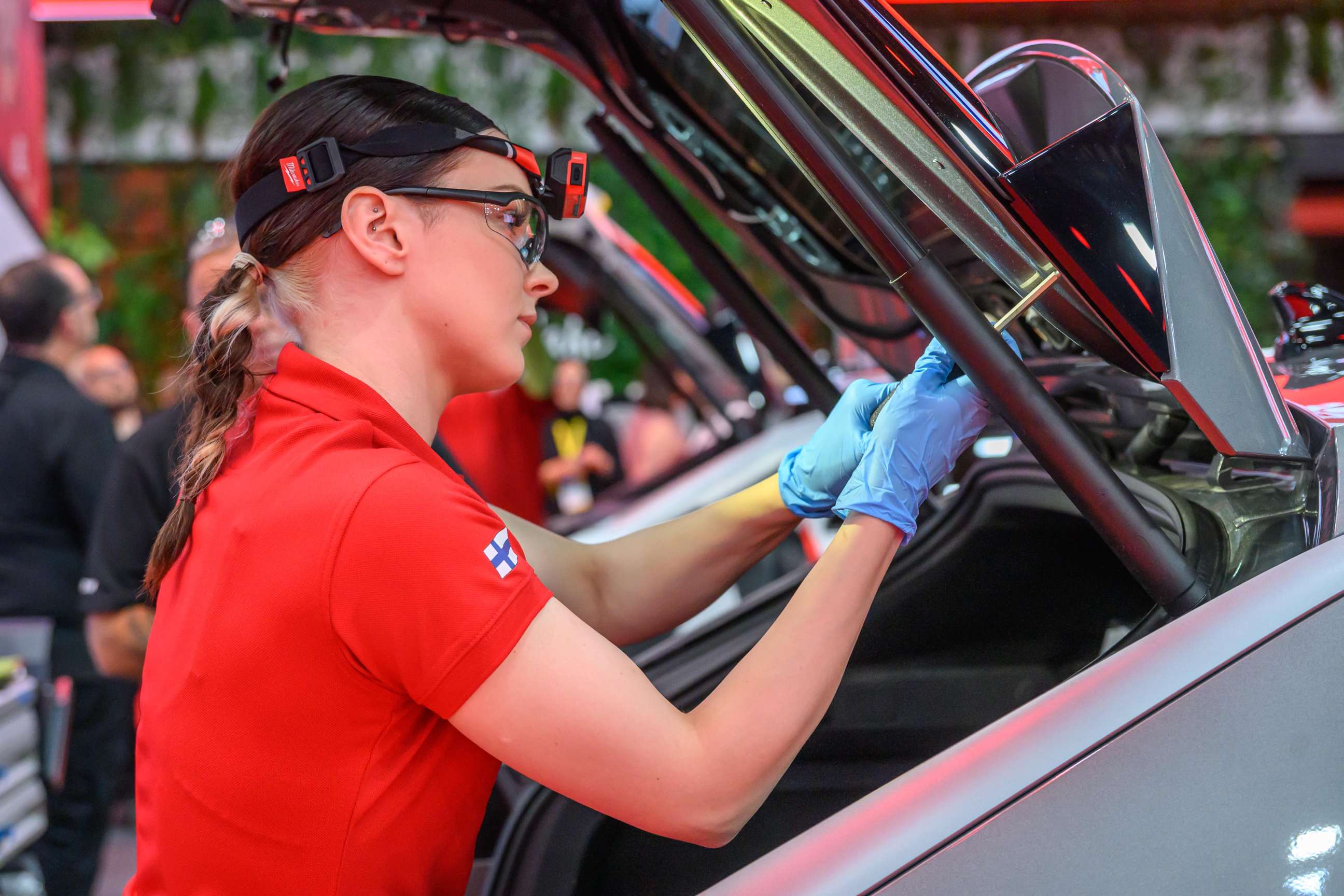 Female technician working on a car