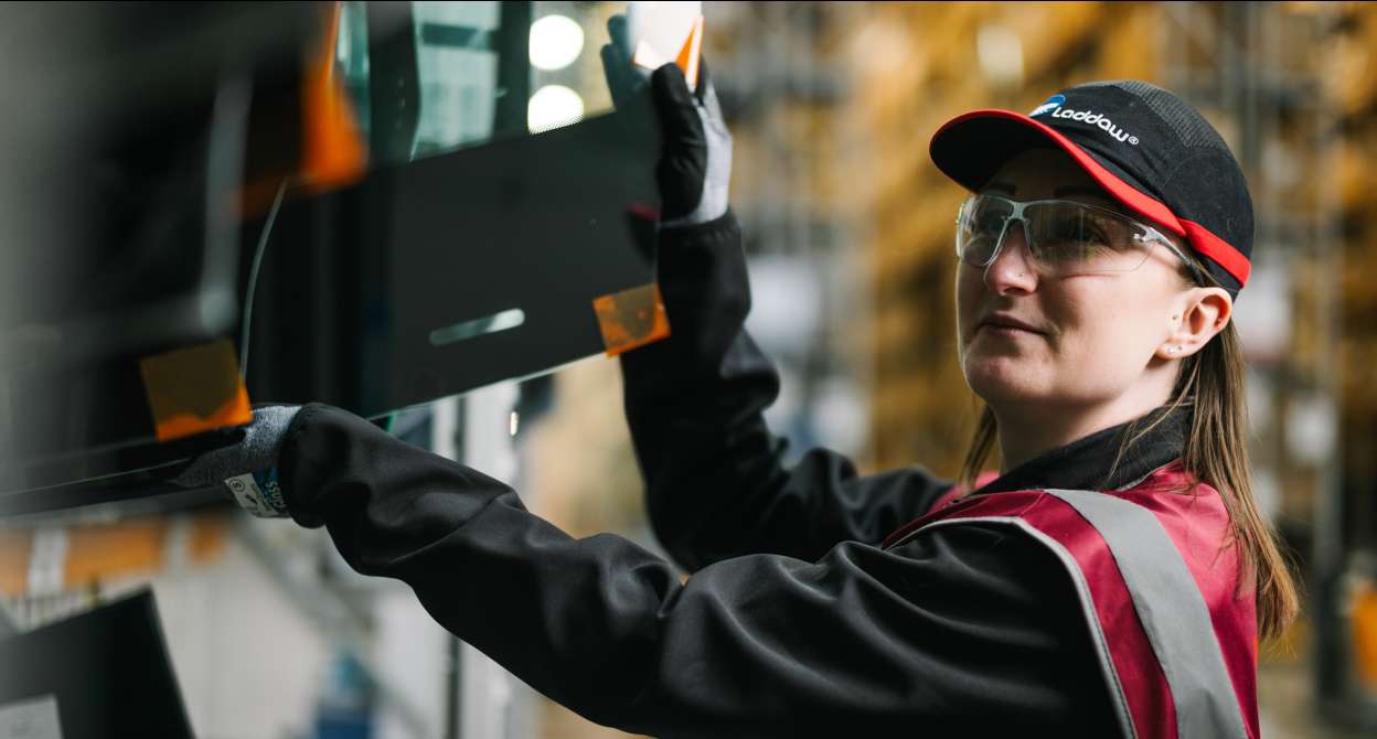 Warehouse colleague handling glass